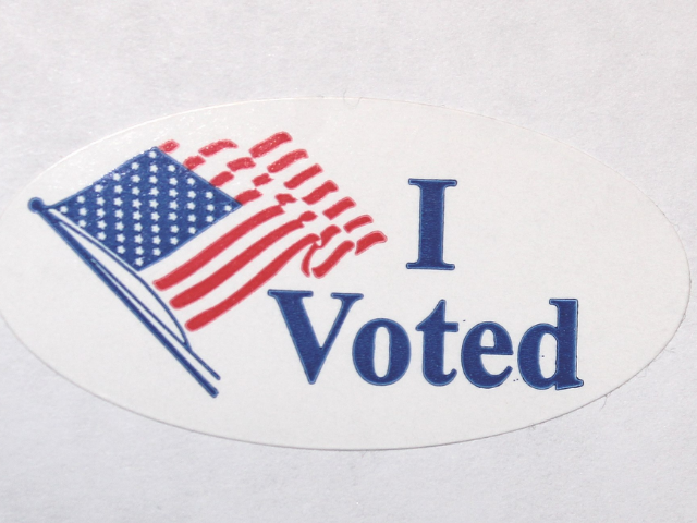 A sticker with an American flag and "I Voted" in blue text. 