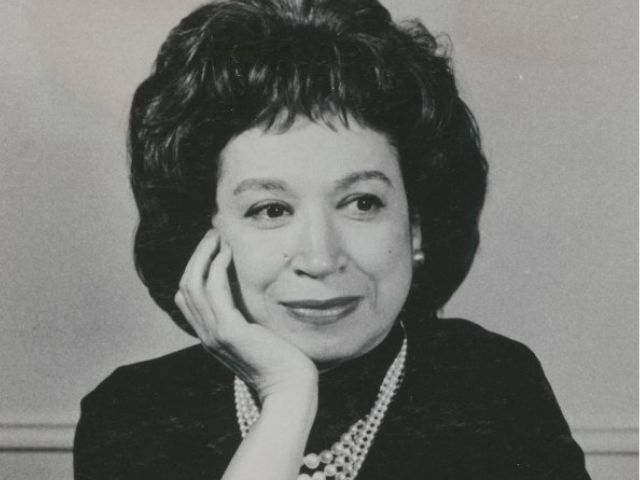 Alice Childress wearing a dark outfit and a pearl necklace.