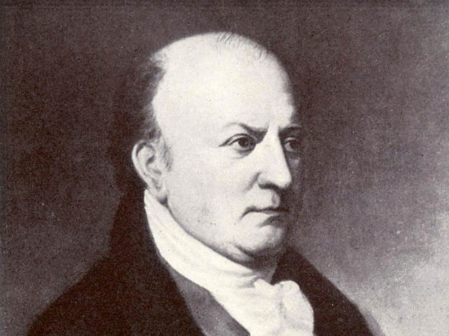 A stern looking Thomas Cooper wearing a dark color coat, vest, and white necktie. 