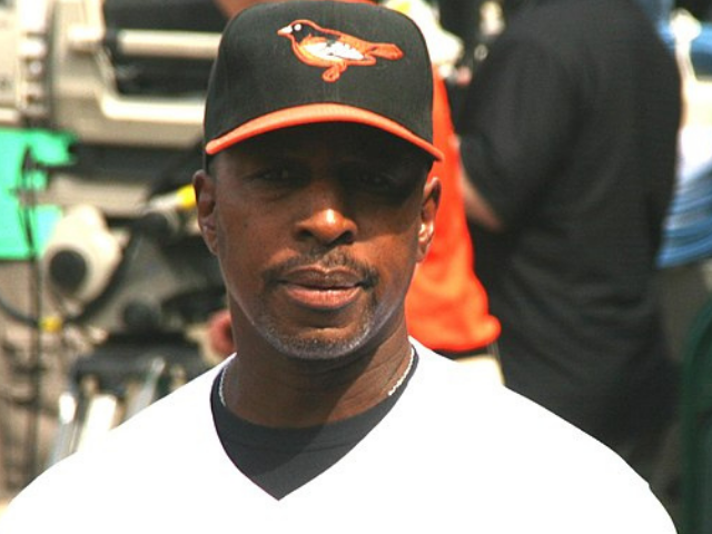 Willie Randolph wearing a black and orange baseball cap with an orange outline bird in the middle. 