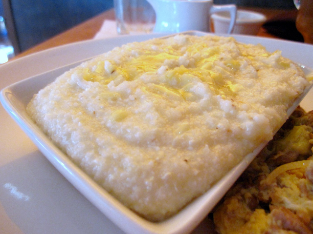 Creamy white grits on a white plate. 