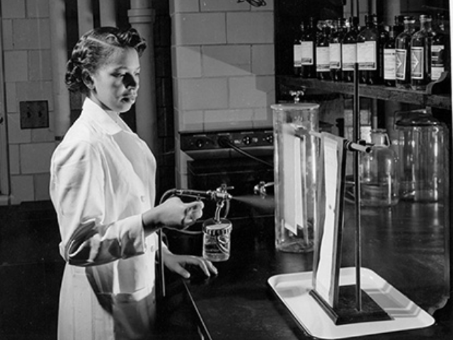 Black and white photograph of Alma Hayden working in a laboratory