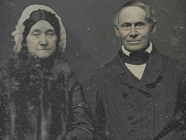Robert Mills and his wife Eliza both wear dark 1800s clothing