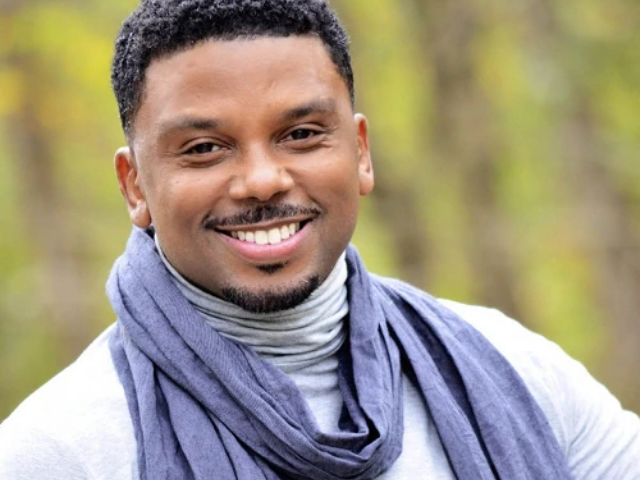 color photograph of Carl Anthony Payne wearing blue scarf