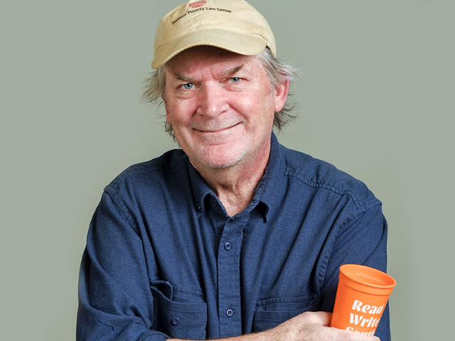 Photograph of George Singleton wearing blue polo-type shrt and baseball cap