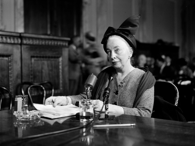 Grace Lumpkin sitting at desk speaking into microphone