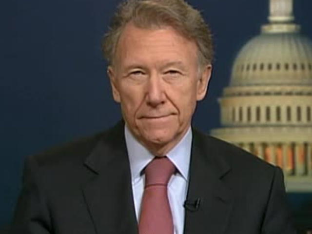 Color photograph of Jim Hoagland with picture of US Capitol in background