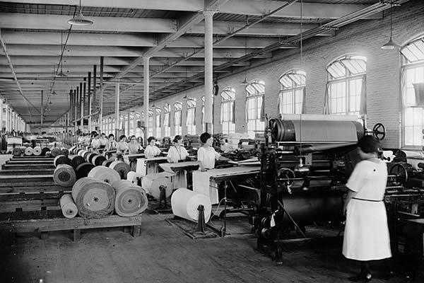 Cloth inspection by a number of women in a textile mill in 1910.
